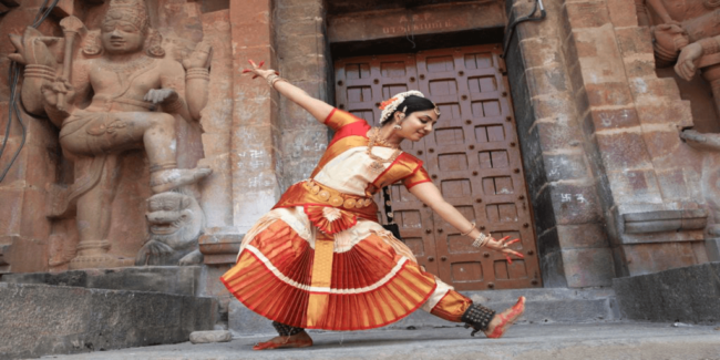 A girl performing adavus, a rhythmic movement of Bharatanatyam in a dance school in Illinois